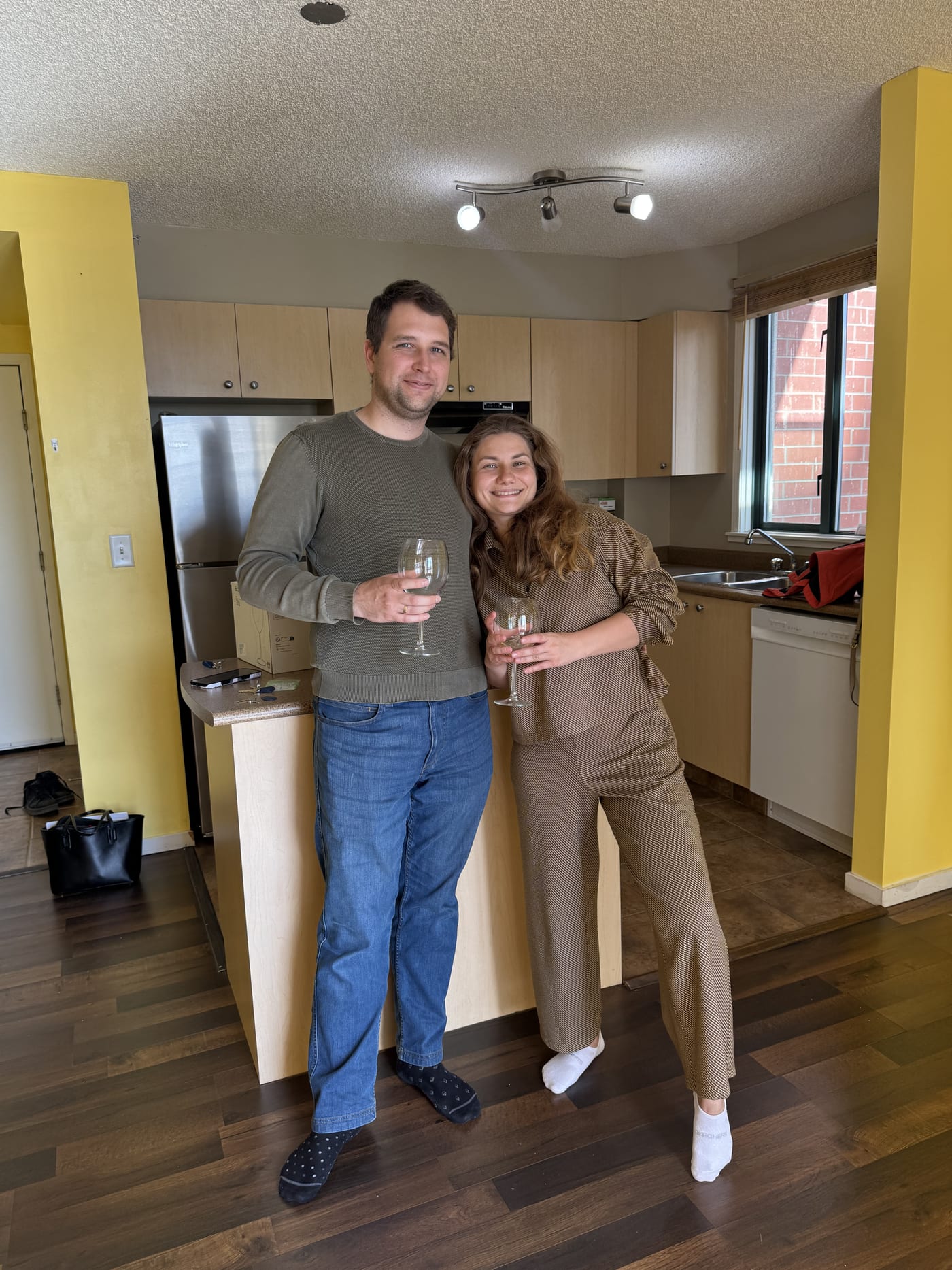 Clients toasting with wine in their new condo
